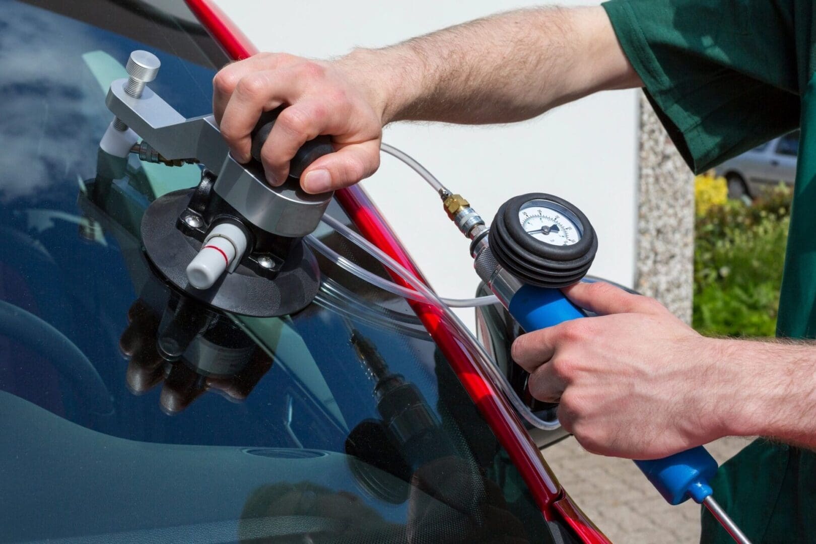 Glazier repairing windscreen after stone chipping damage