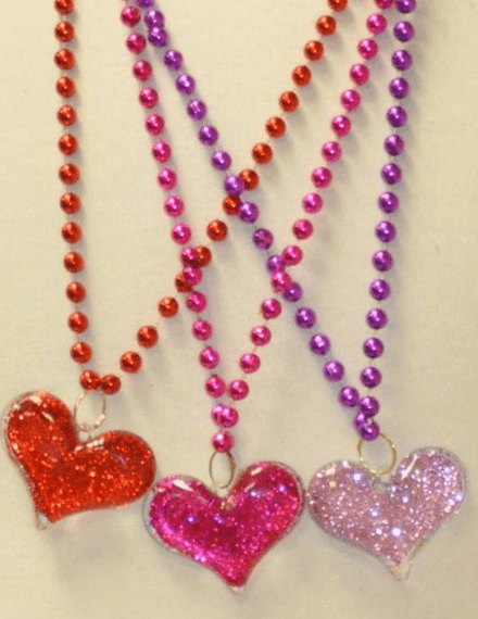 Three colorful bead necklaces with heart pendants